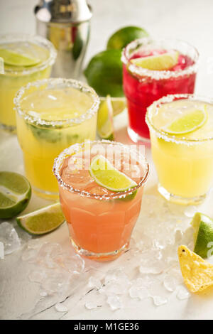 Variety of margarita cocktails with salted rim and lime on white background Stock Photo