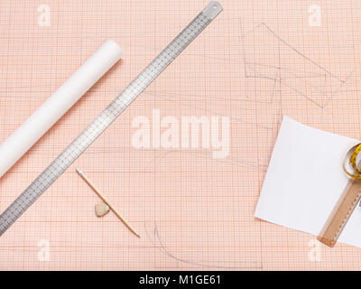 top view of drawing tools for creating of clothing pattern on sheet of graph paper Stock Photo