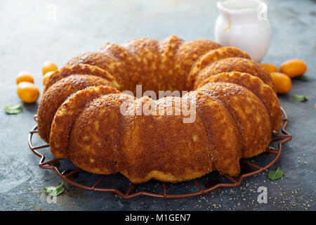 Winter citrus pound bundt cake with orange zest maple cirup Stock Photo