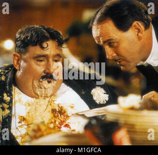 MONTY PYTHON'S THE MEANING OF LIFE 1983 Universal Pictures film with John Cleese at right and Terry Jones Stock Photo