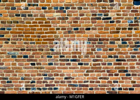 Old multi-coloured red brick wall full frame texture background Stock Photo