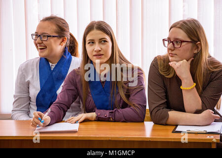 CHAPAEVSK, SAMARA REGION, RUSSIA - JANUARY 26, 2018: College in Chapaevsk city. Three female students at a desk Stock Photo