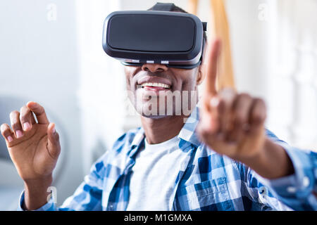 Nice pleasant man using modern technology Stock Photo