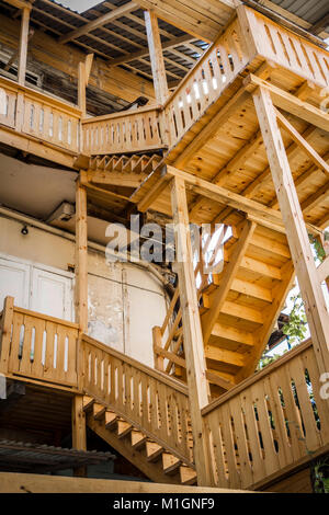 Wooden staircase to the upper floors of a private multi-storey building. Stock Photo
