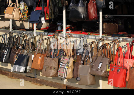 Market for handbags and purses on the street in Pernik, Bulgaria – Jan 27, 2018. Imitation of brand bags. Fake branded ladies handbags. Stock Photo