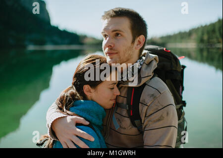 Man and woman in love hugging at a mountain lake. Stock Photo