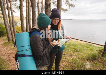 Two young tourist determine the route map and compass. Stock Photo