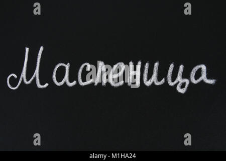 The inscription on a chalkboard in Russian: Maslenitsa. Traditional dishes on the holiday Carnival Maslenitsa Shrovetide Stock Photo