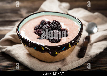 Vegan nice cream with frozen banana, blueberry and raspberry in a bowl Stock Photo