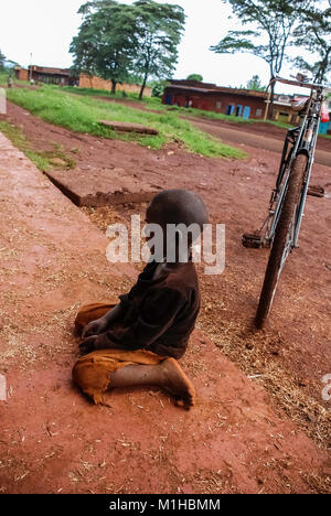 Thika Kenya November 8 2008.Boy sitting on the concrete. Stock Photo