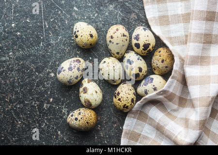 Fresh guail eggs on old kitchen table. Stock Photo