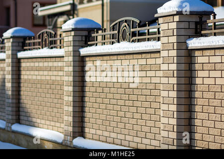 Hard long solid rural fence made from aged white bricks Stock Photo