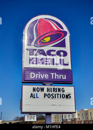 Large Taco Bell Restaurant sign with logo and message board, now hiring all positions, for the drive thru lanes in Montgomery Alabama, United States. Stock Photo