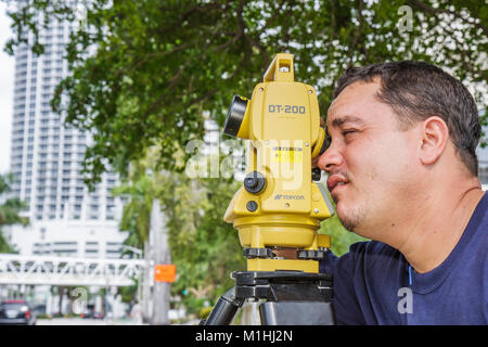 Miami Florida,theodolite,measures angles,Hispanic man men male,survey,interview,interviews,interviewing,Topcon,working,work,employee worker workers st Stock Photo