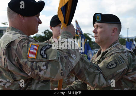 Col. Robert Ryan (left), commander, 3rd Brigade Combat Team, “Broncos,” 25th Infantry Division, transfers responsibility from outgoing brigade senior enlisted advisor, Command Sgt. Maj. Alan E. Michaud at Weyand Field, Schofield Barracks, Hawaii, on Jan. 5, 2018. Command Sgt. Maj. Michael J. Spear assumed responsibility of the brigade from Michaud.  (U.S. Army Stock Photo