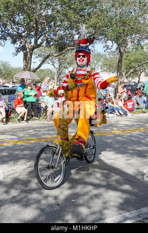Ronald McDonald riding a bike during the Hobe Sound Christmas Parade, Hobe Sound, Martin County, Florida, USA