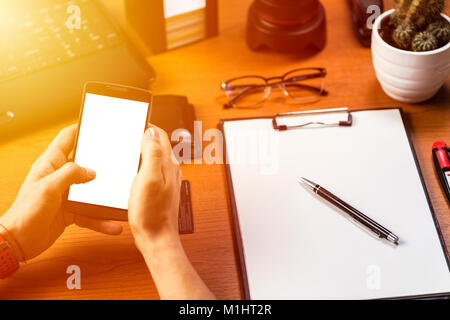 Businessman working with smartphone and make notice. Useful as mock-up, presentation product business. Stock Photo