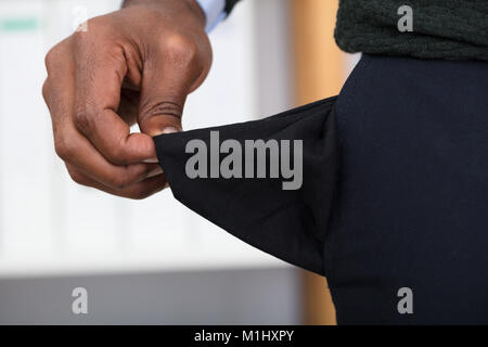Close-up Of A Man Holding Empty Pocket With His Hand Stock Photo