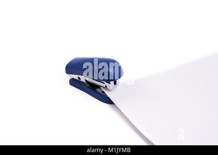 Small blue stapler with paper on white background Stock Photo