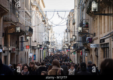 BORDEAUX, FRANCE - DECEMBER 27, 2017: Sainte Catherine street during rush hour crowded with people shopping among the numerous shops of the street, on Stock Photo