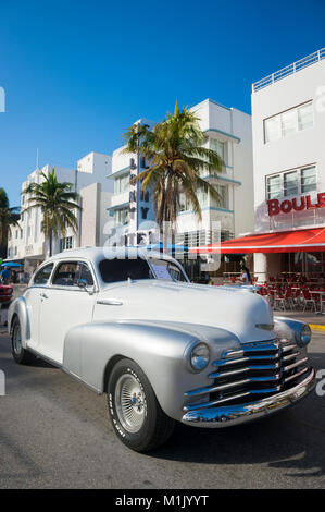 MIAMI - January 13, 2018: A vintage American automobile parks on Ocean Drive during the annual Art Deco Weekend classic car show in South Beach.