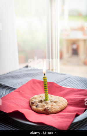 The perfect birthday treat of a fresh baked chocolate chip cookie Stock Photo