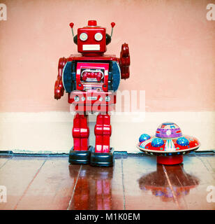 Vintage robot toy and UFO toy  on a wooden floor Stock Photo