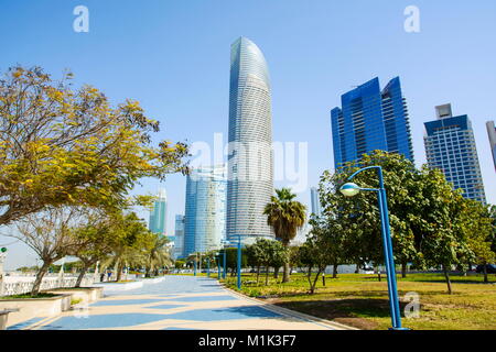 Abu Dhabi Corniche walking area with landmark view of modern buildings on Corniche road, UAE Stock Photo