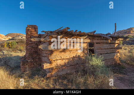 Kirk's Cabin, built as a seasonal shelter by a rancher, with adzed logs and a stone chimney, in Salt Creek Canyon in The Needles District of Canyonlan Stock Photo