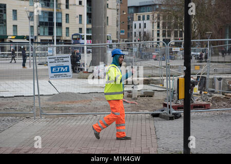 A builder in front of a city building size in the centre of Bristol Stock Photo
