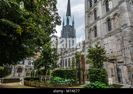 The garden and cloister of the medieval Notre Dame Cathedral of Rouen France in the Normandy region with scaffolding on the tower. Stock Photo