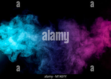 Dense multicolored smoke of   red, purple and pink colors on a black isolated background. Background of smoke vape Stock Photo