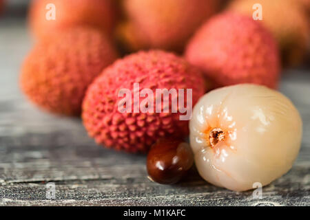 Lychee fruits and seed on wooden background Stock Photo