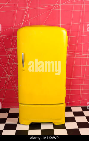 yellow old vintage retro refrigerator on a pink background Stock Photo
