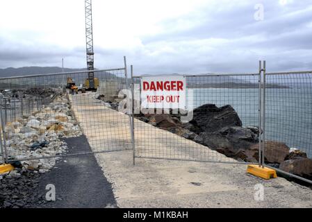 Gated area with Danger Keep Out sign at construction site on causeway with crane and other machinery in Coffs Harbour Australia as on 31 Jan 2018. Stock Photo
