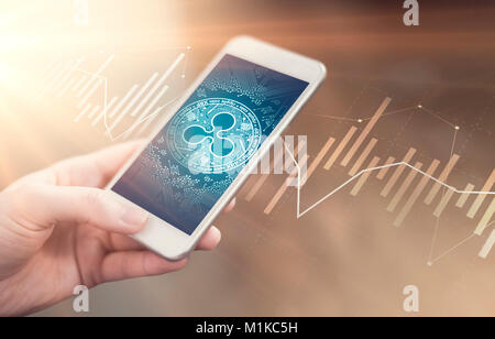 Ripple coin symbol on mobile app screen. Ripple price grows or falls. New digital money. Stock Photo