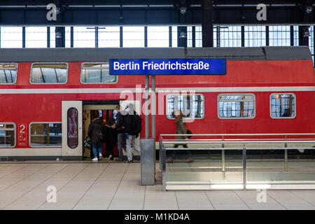 Passengers boarding a train at the Berlin Friedrichstrasse rail station in the German capital Berlin Stock Photo