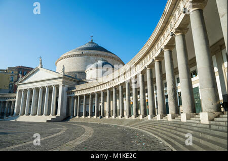 Scenic afternoon view of the curved colonnade architecture of the Basilica Reale Pontificia San Francesco di Paola (built in 1816) in the Piazza del P Stock Photo