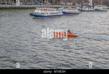 Central London, United Kingdom - December 29, 2016: Lifeboat crusing on the River Thames near Waterloo Bridge. Stock Photo