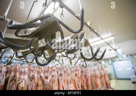 close up image of a meat hooks in a slaughterhouse with mutton ...