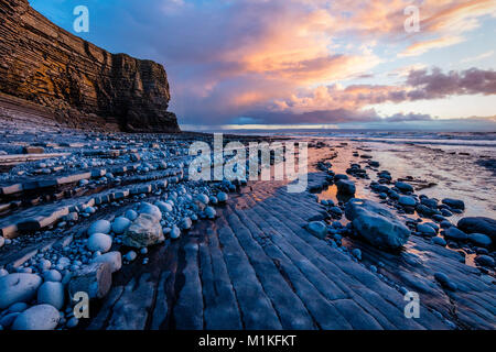Winter sunset at low tide at Nash Point on the Glamorgan Heritage Coast of South Wales UK Stock Photo