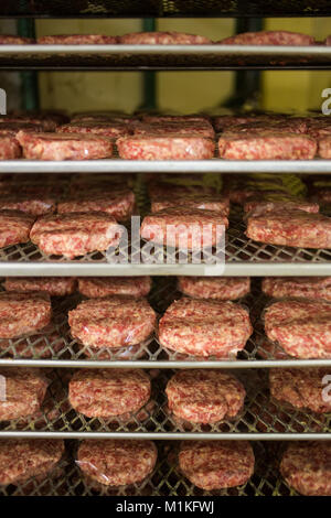 Close up images of burger patties on a rack in a butchery Stock Photo