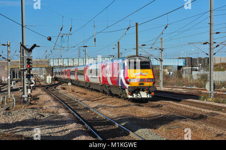 Virgin East Coast Express heads away north from Peterborough, Cambridgeshire, England, UK Stock Photo