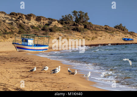 Boats left on the beach after landings of illegal immigrants in Torre Salsa Stock Photo