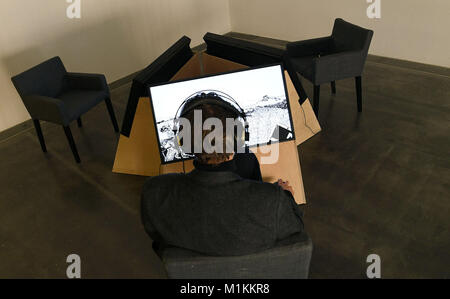 Oldenburg, Germany. 30th Jan, 2018. An employee of the Edith Russ house for media art sitting in front of the mixed media installation 'The Solar Girl' by Ganzeer in Oldenburg, Germany, 30 January 2018. Comics in art, so-called graphic nivels, are mirrors of society. History and trends of the current art form are the subject of the three Oldenburg museums, the Edith Russ house für media art, the Horst Janssen museum und the city museum. (ATTENTION EDITORS: FOR EDITORIAL USE ONLY IN CONNECTION WITH CURRENT REPORTING; MANDATORY CREDIT) Credit: Carmen Jaspersen/dpa/Alamy Live News Stock Photo