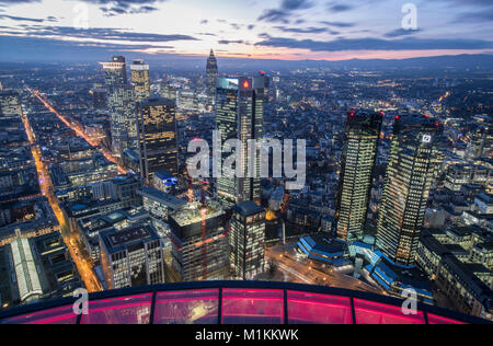 Frankfurt am Main, Germany. 30th Jan, 2018. The red lit glass enclosure of the Main Tower frames the view of the bank skyline in Frankfurt am Main, Germany, 30 January 2018. On the right are the twin towers of the Deutsche Bank, beside it on the left the Sparkasse tower, in the centre is the Trade Fair Tower with its characteristic pyramid tip. The Deutsche Bank presented its annual report for 2017 on 02 January 2018. Credit: Boris Roessler/dpa/Alamy Live News Stock Photo