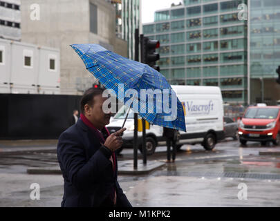London,UK,31st January 2018,A man walks with a small umbrella to  try and avoid the heavy downpours of rain in Victoria London©Keith Larby/Alamy Live News Stock Photo