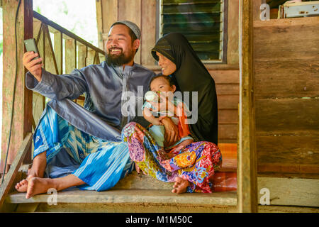 KRABI, THAILAND - MAY 2, 2015: Lovely Muslim family selfie themselves. in home in Lanta island of Krabi, Thailand Stock Photo