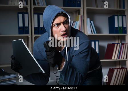 Young man in industrial espionage concept Stock Photo