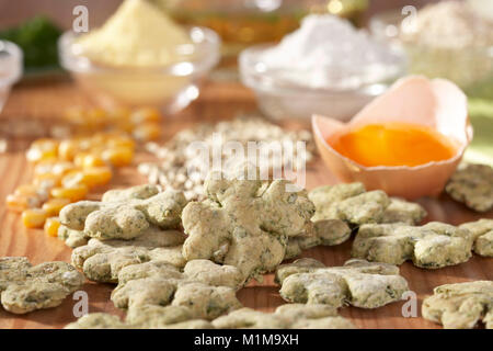 Domestic dog. Ingredients for biscuits as rewards for dogs and freshly baked biscuits. Germany Stock Photo
